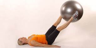 Holding the stability ball between your raised legs creates the lower press